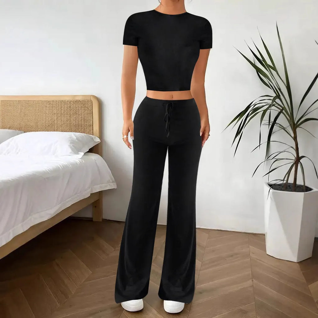Black high-waist trousers and short sleeve t-shirt co-ord set for women.