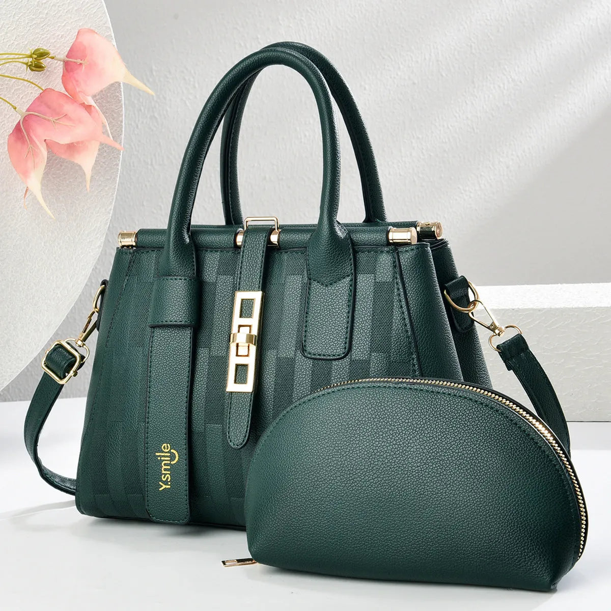 A pair of round black and light khaki PU leather crossbody bags with adjustable straps.