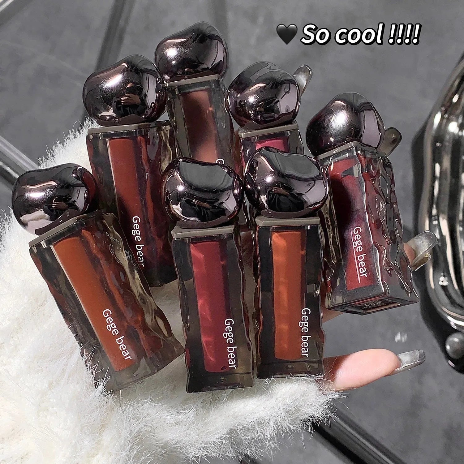 Glacier Lava mirror lip gloss tube with built-in mirror, shown in one of seven available shade numbers.