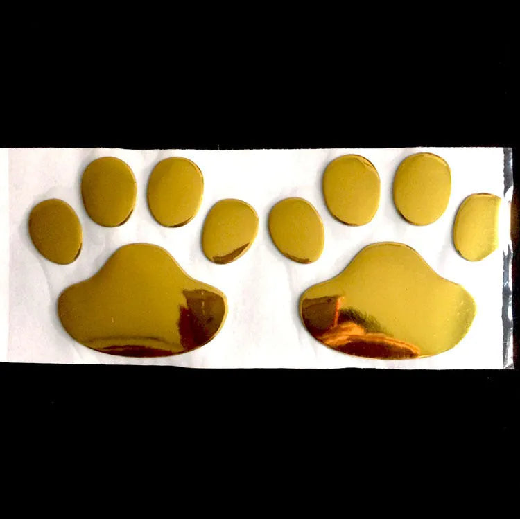 Pair of hand-shaped brush dog footprint PVC car stickers in red, shown against a car bumper.