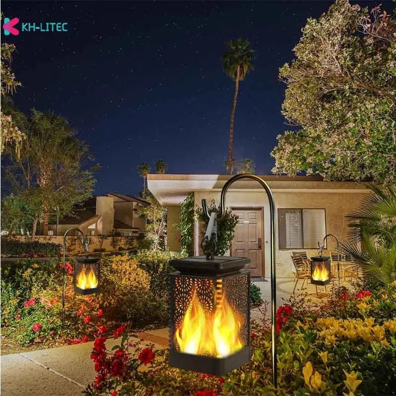 Set of four black solar-powered flame torch lights with flickering LED effect for garden pathways