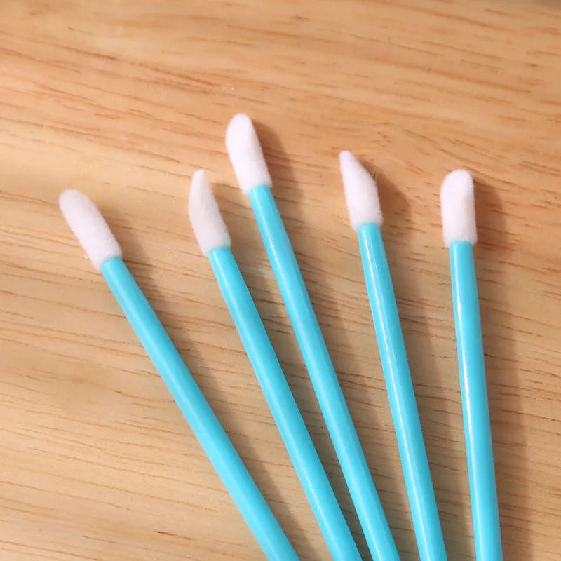 Disposable lip brushes with flocked heads and black handles in various colours