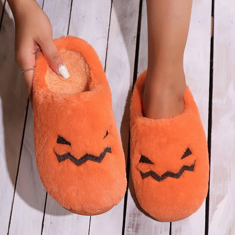 Orange pumpkin-themed plush slippers with a non-slip sole for indoor home wear.