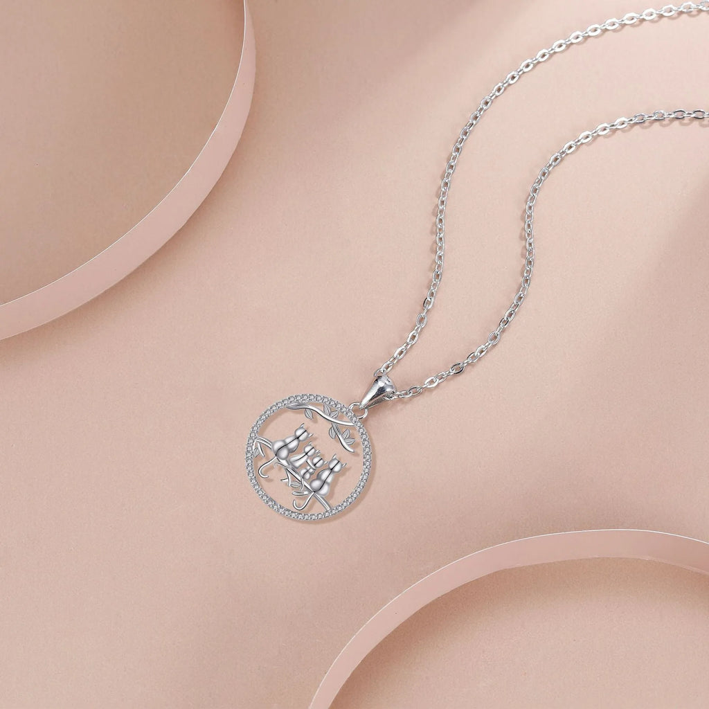Four kitten pendant necklace with copper chain and cross link design