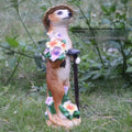 Straw hat mongoose ornament set with gardening tools in yellow brown and straw colour variations