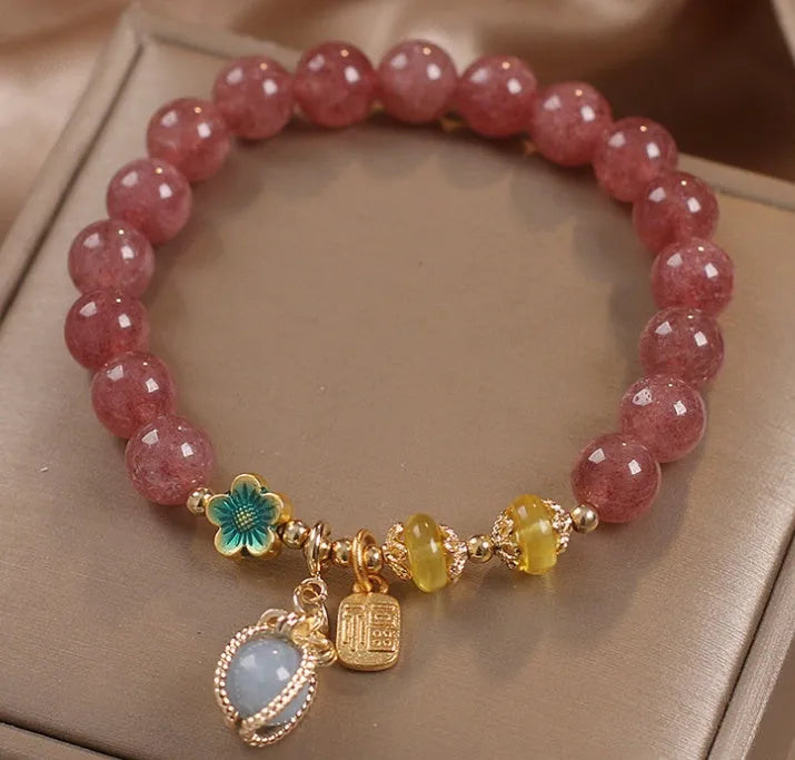 Red strawberry quartz and rhinestone beaded bracelet with an alloy clasp.