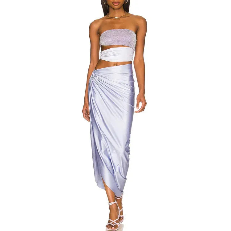 Purple one-piece swimsuit with hollow design and matching wrap skirt on white background