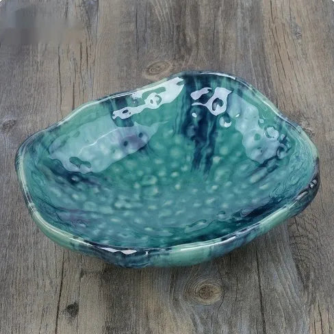 Japanese-style ceramic sashimi bowl with irregular shape and floral decoration