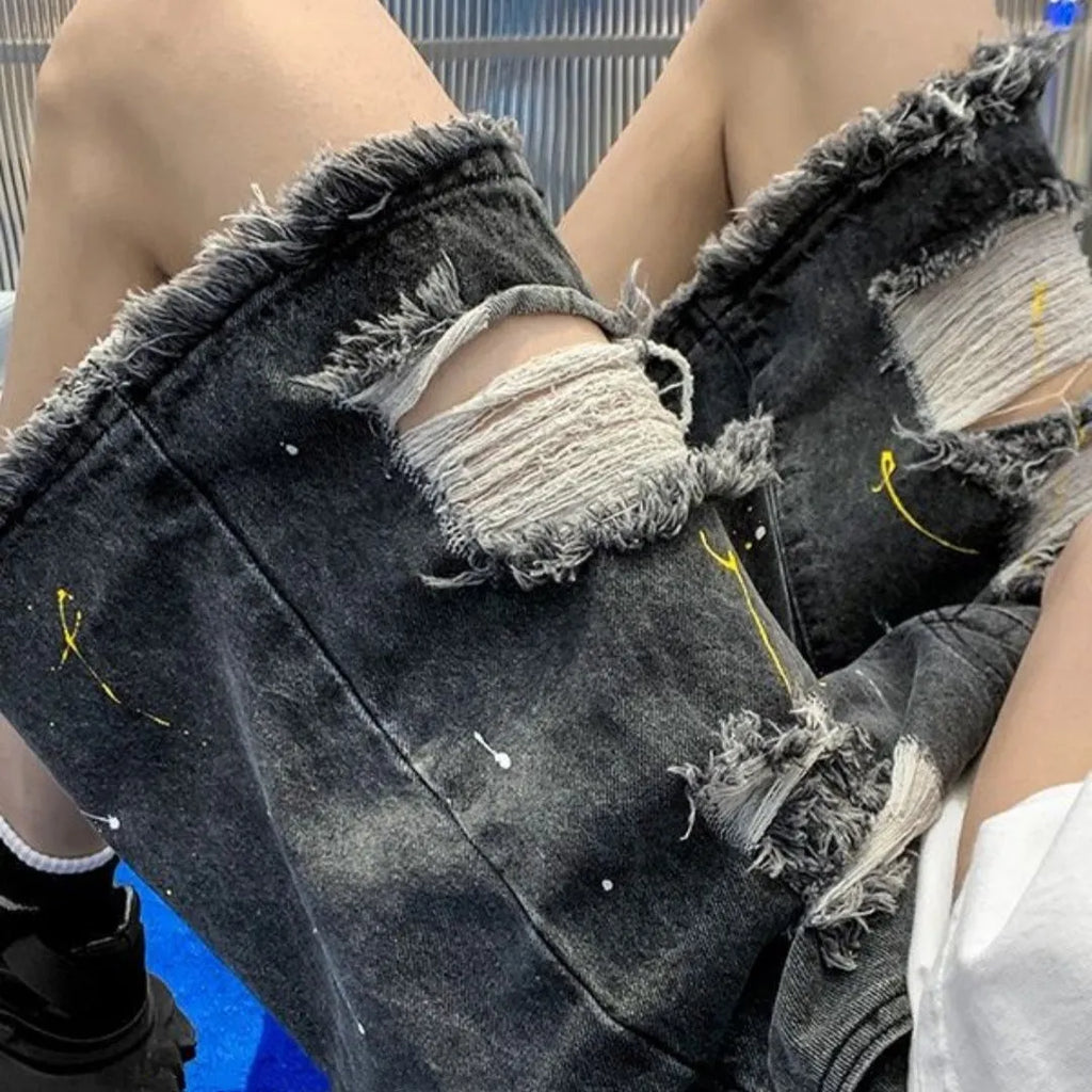 Men's loose fit water washed denim shorts with hole details in light blue, showing fifth pants length.
