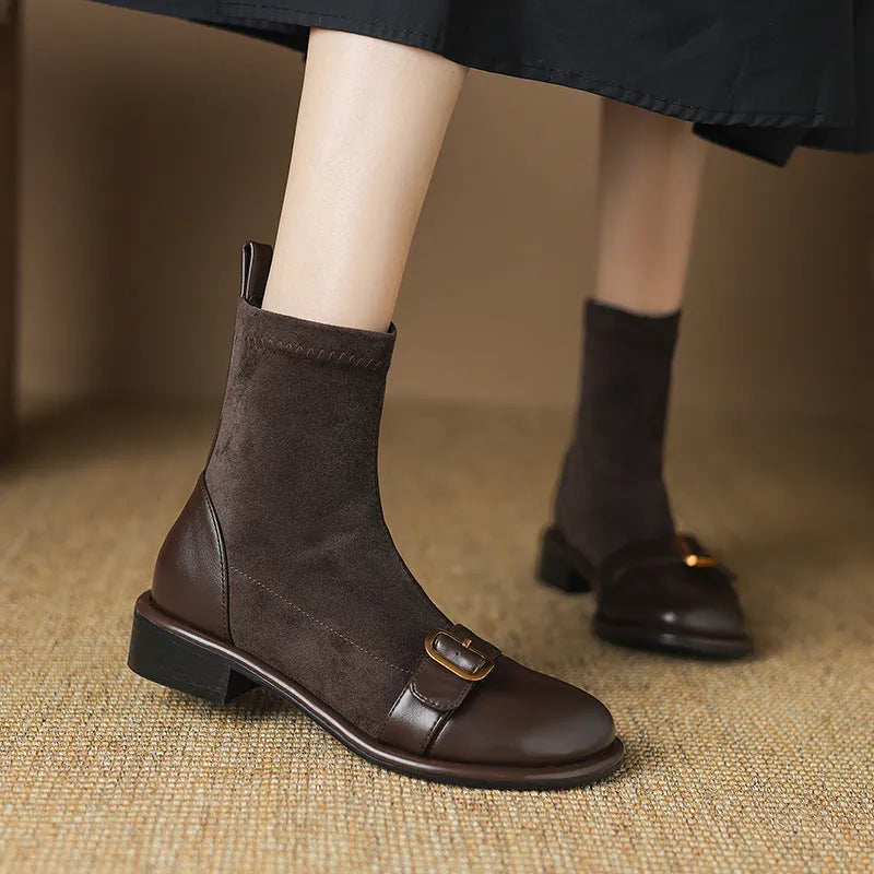 Women's black low-heel Martin ankle boots with front lace-up and belt buckle detail stitching.