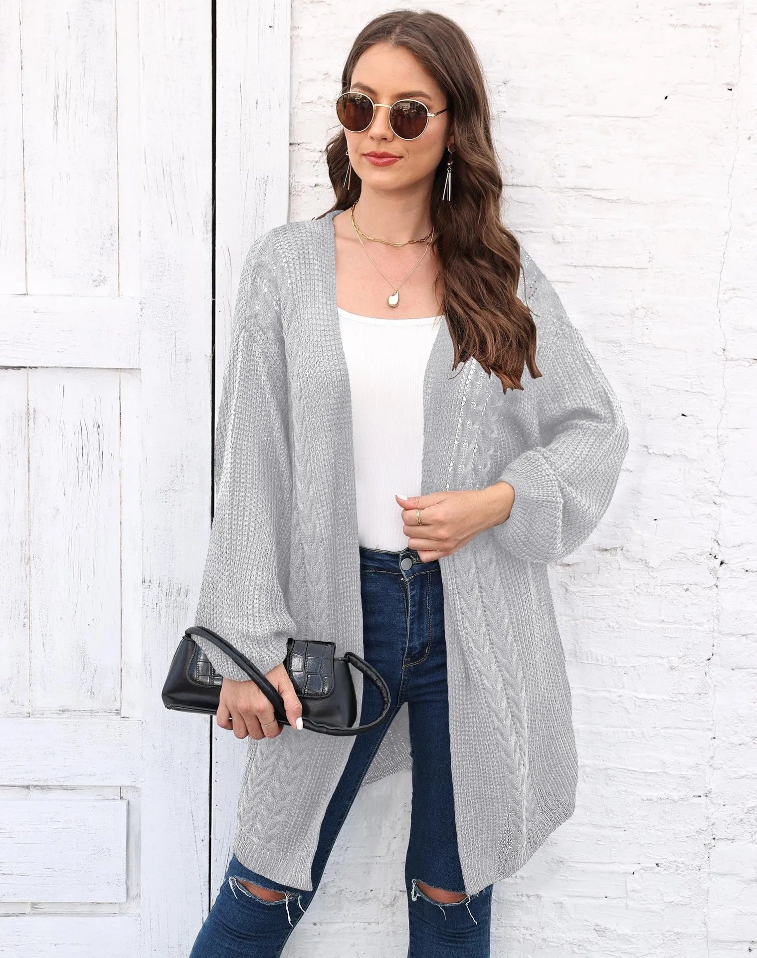 Women's loose brown acrylic sweater coat hanging on a hanger