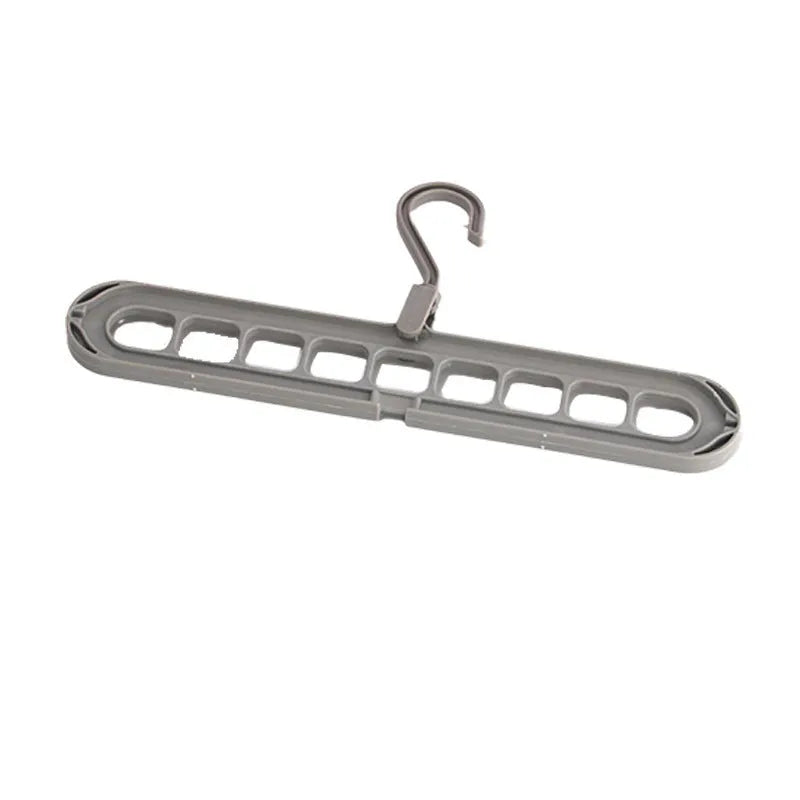 A green plastic multifunctional hanger with nine holes for trousers, shown in a folded and unfolded position.