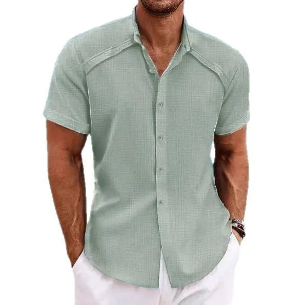 Men's solid colour short sleeve casual shirt in cotton blend fabric on a hanger.