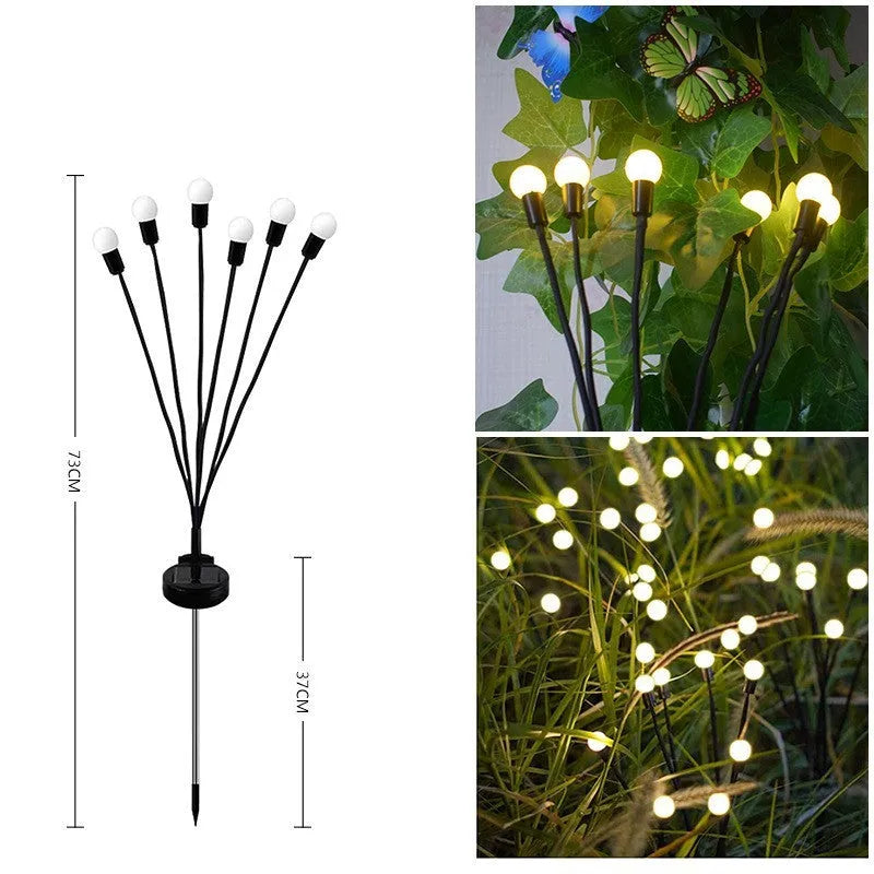 Solar-powered LED garden ground light with stainless steel spike inserted in lawn showing automatic dusk-to-dawn operation