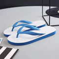 Men's rubber flip-flops in green with a fish label on the strap, showing the non-slip tread pattern on the sole.
