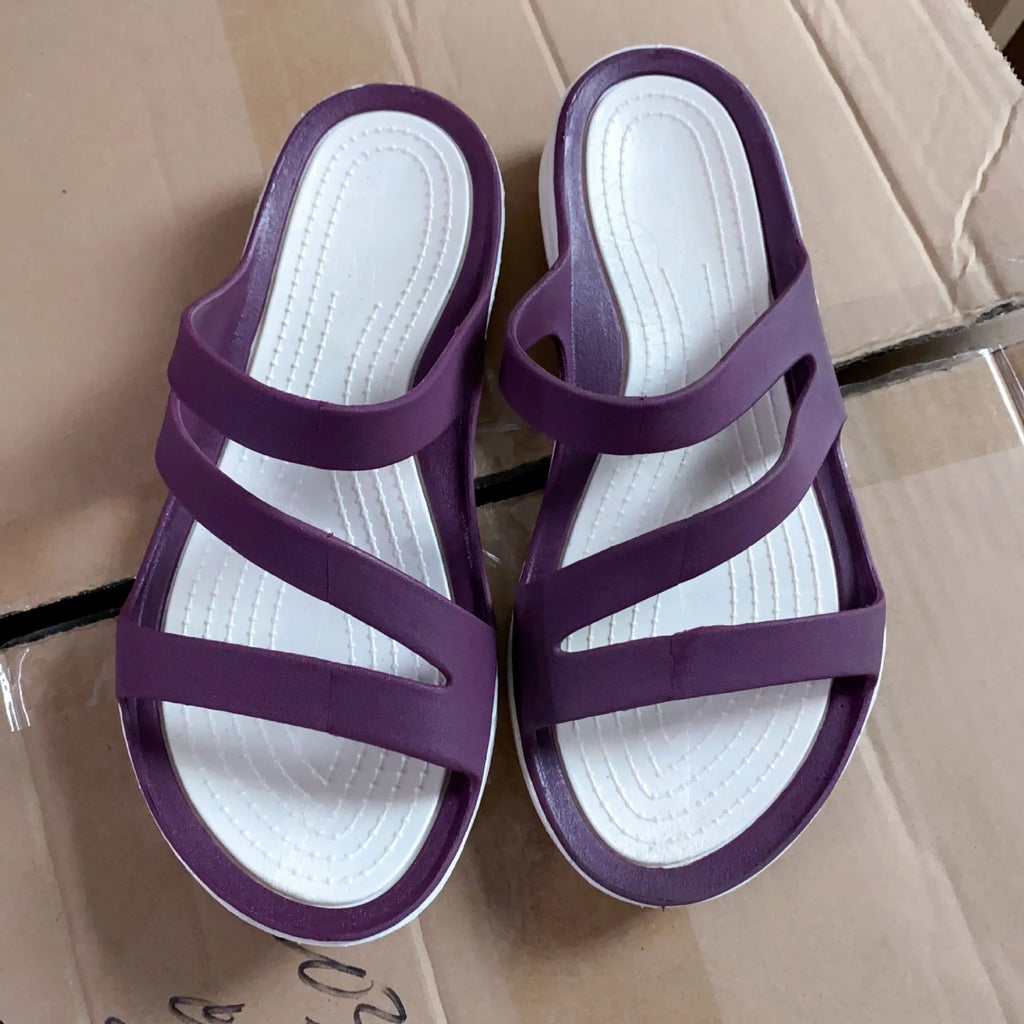 Women's solid colour breathable summer sandals in red, shown from the side.