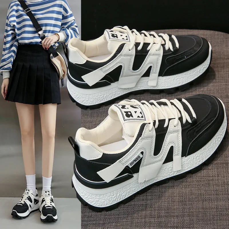 Unisex low-top running sneaker in black with round toe, lace-up front, and rubber sole on a white background.