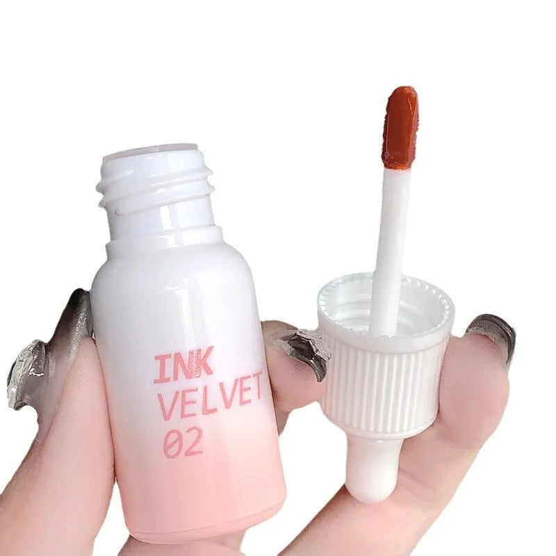 Mirror Lip Lacquer lip gloss tube in one of four shades: Spring Day Wilderness, Orange Tabby Cat Diary, Low-key Charming, or Misty Berry.
