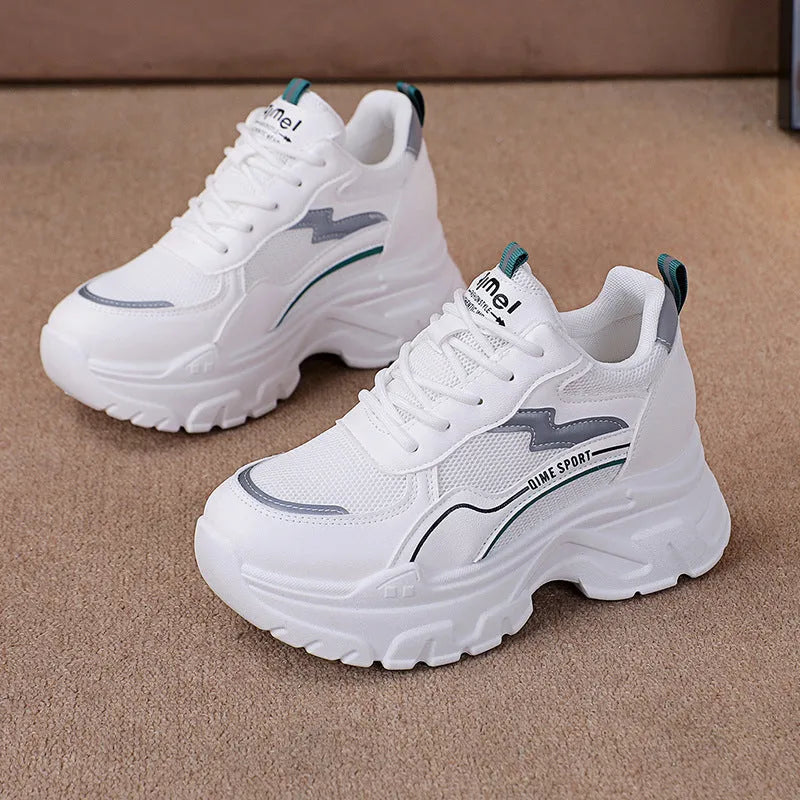 White women's dad shoes with cross shoulder straps, breathable mesh, and a rubber sole.