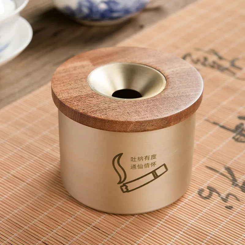 Brass ashtray with wooden lid in copper construction showing centre hole design