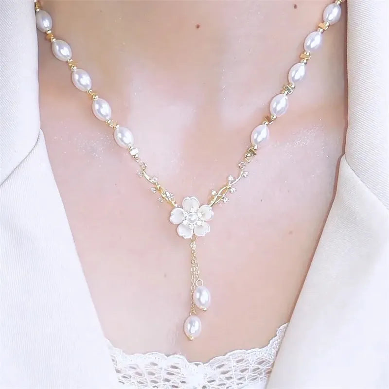 Alloy pearl necklace with floral and rose design elements on a pearl chain.