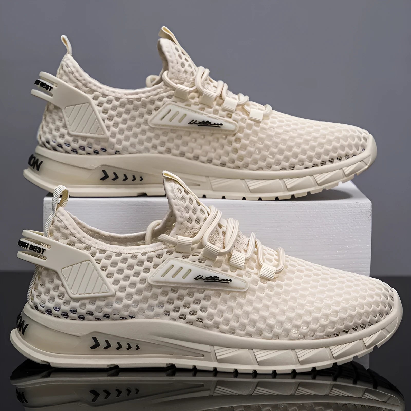 Men's beige mesh sneakers with lace-up front and synthetic leather upper on a flat EVA sole.