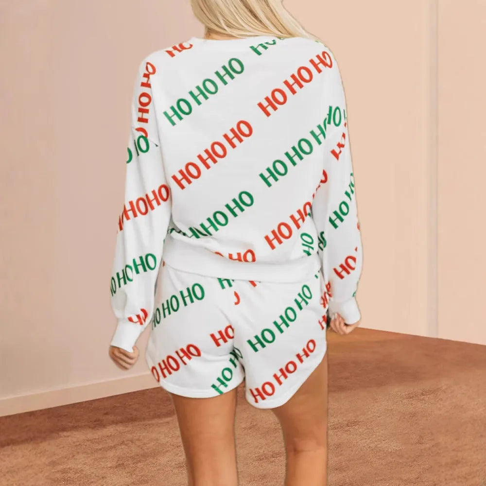 Women's white two-piece suit with a black letters print, featuring a long-sleeved top and matching trousers.