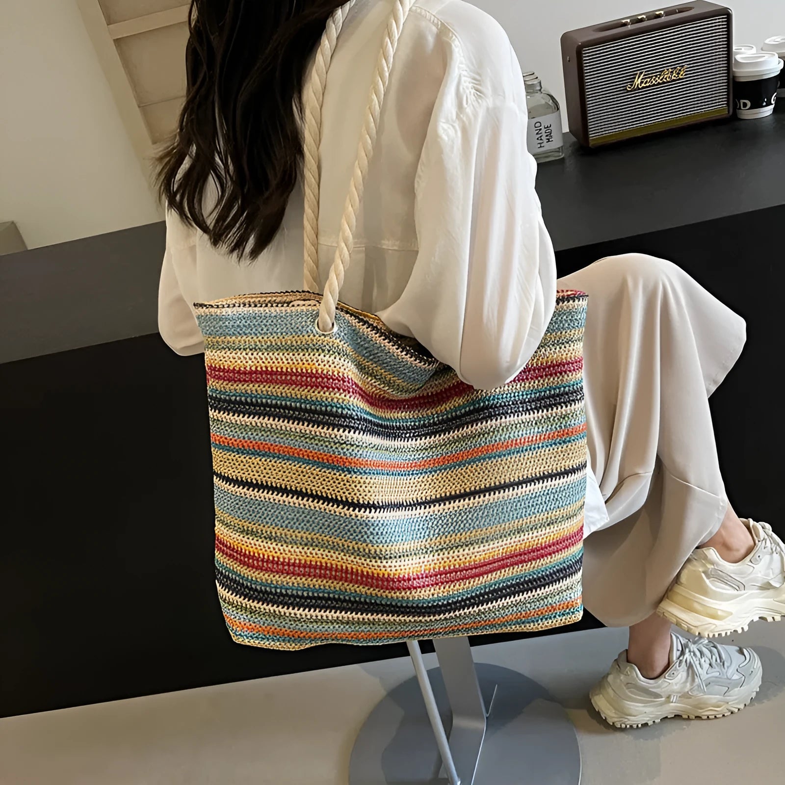 Blue straw woven shoulder bag with single strap showing textured exterior