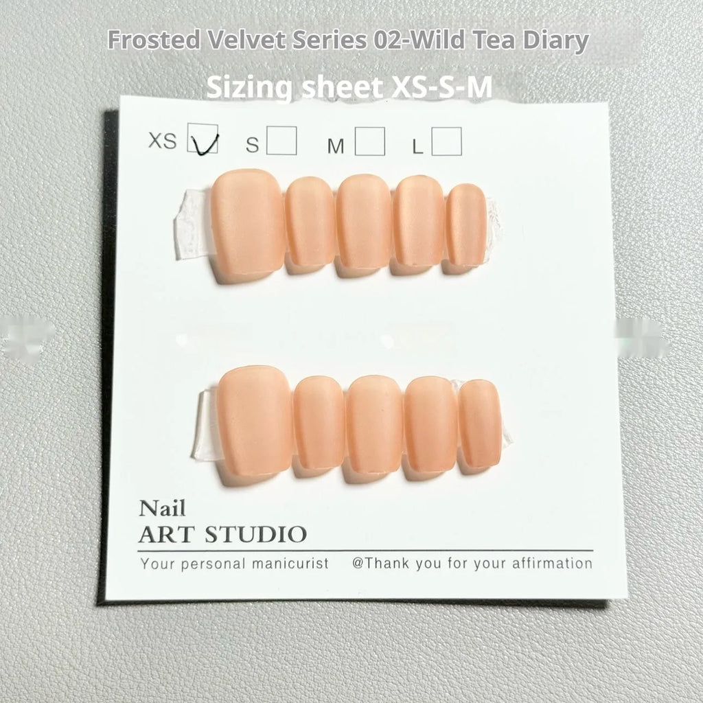 Set of velvet frosted Cat's Eye effect false nails in short ladder sizes on a clear background.