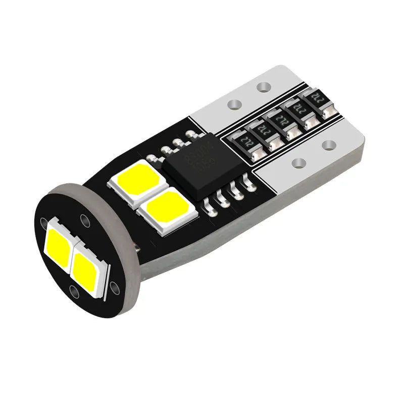 Small white LED car lamp for licence plate lighting on a fibre-glass board.