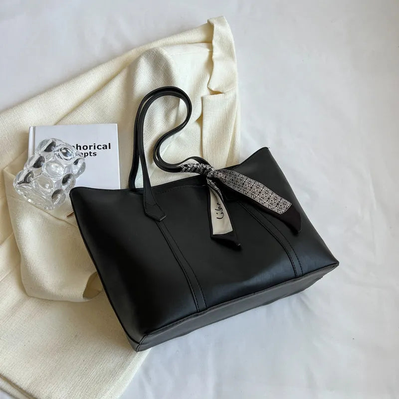 Soft large capacity tote bag with crossbody strap in khaki colour showing outer pocket and sewing line detail