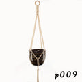 Natural cotton rope woven wall hanging planter holding a small green plant.