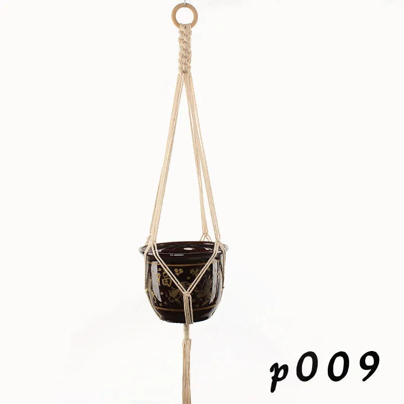 Natural cotton rope woven wall hanging planter holding a small green plant.