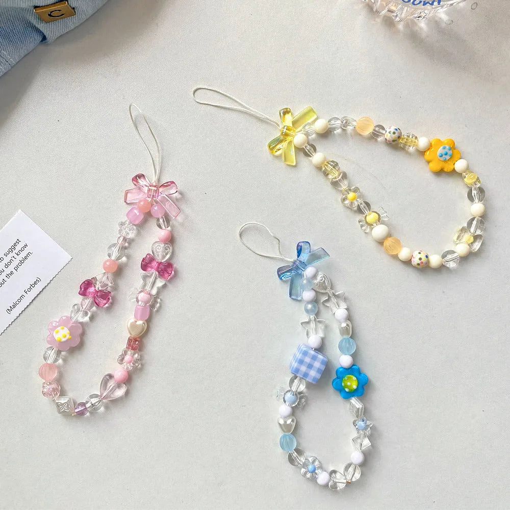 Beaded flower mobile phone lanyard with plastic resin floral decorations in yellow, blue, or pink colours