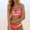Women's red and white striped polyester bikini set and black and white polka dot bikini set.