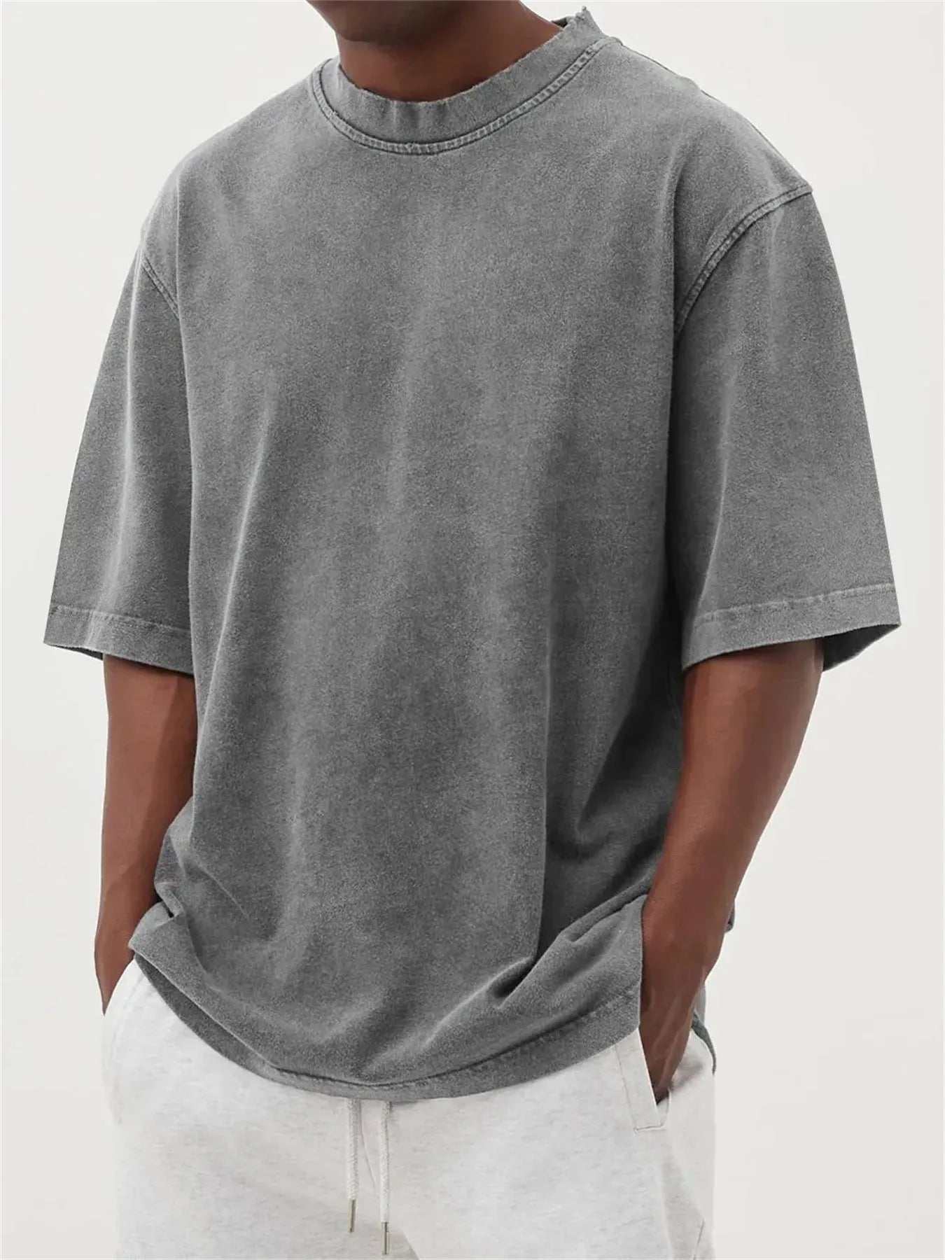 Men's loose fit pullover T-shirt in a stone-washed distressed solid colour, shown in army green.