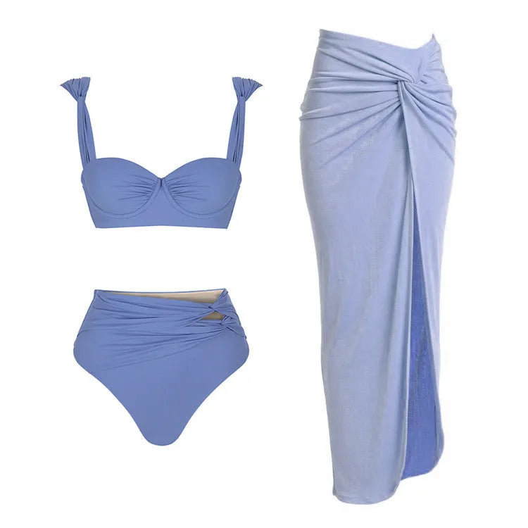 Women's solid colour one-piece swimsuit with gold button and separate matching skirt.