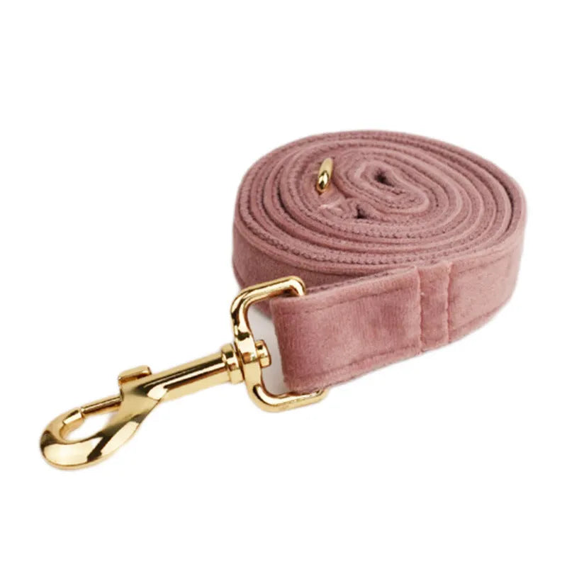 Light purple and pink velvet dog collar with matching leash and bow accessory set on a white background.