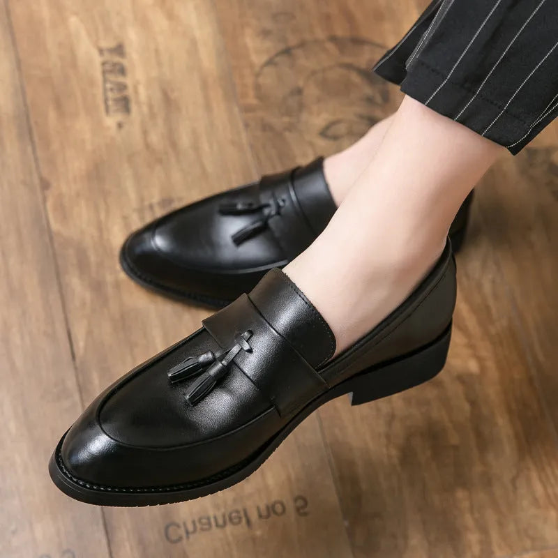 Men's black slip-on business shoes with tassel detail on artificial leather upper