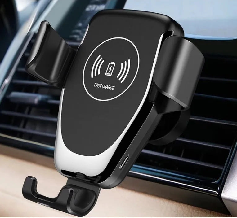 Black Qi wireless car phone mount holding an iPhone, showing automatic clamping arms and a vent clip installation.