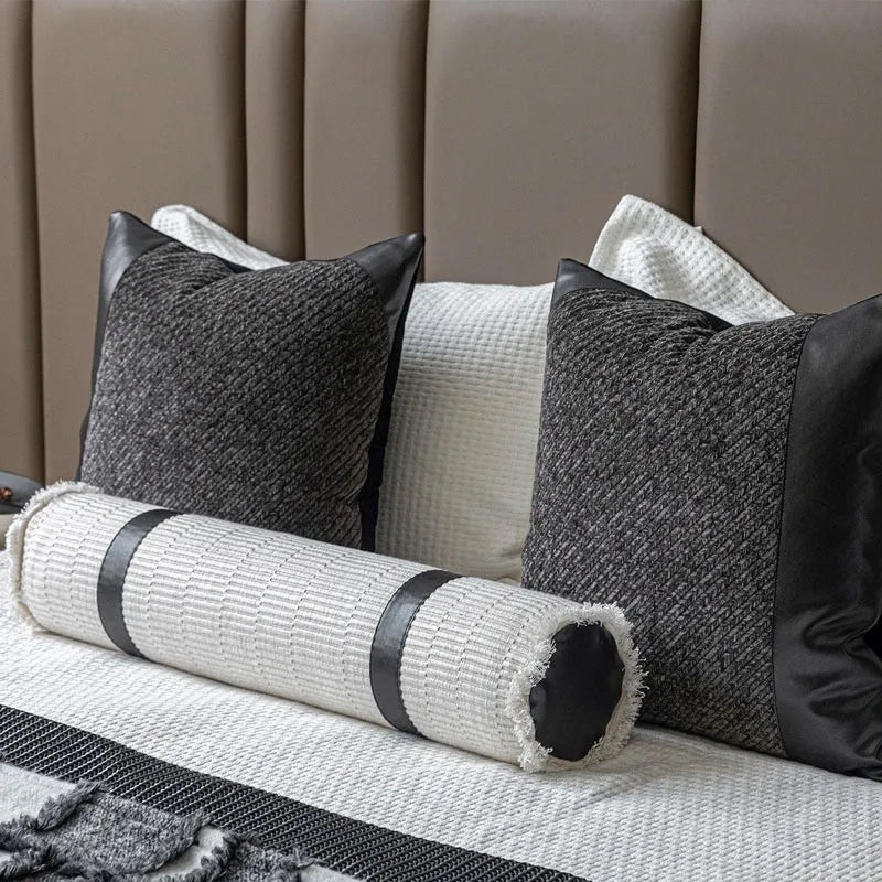 Grey and white plaid polyester bed runner blanket set with matching pillowcase and round leather-look cushion on a bed
