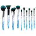 Ten clear crystal diamond shank foundation brushes with artificial fibre heads, shown in a set.