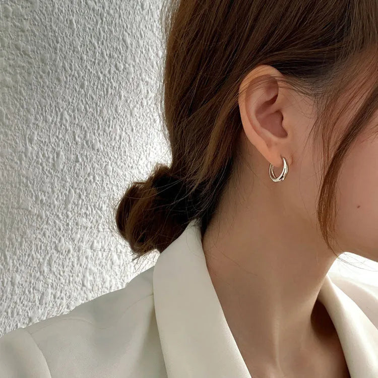 Women's geometric water drop earrings in gold and silver with minimalist round design