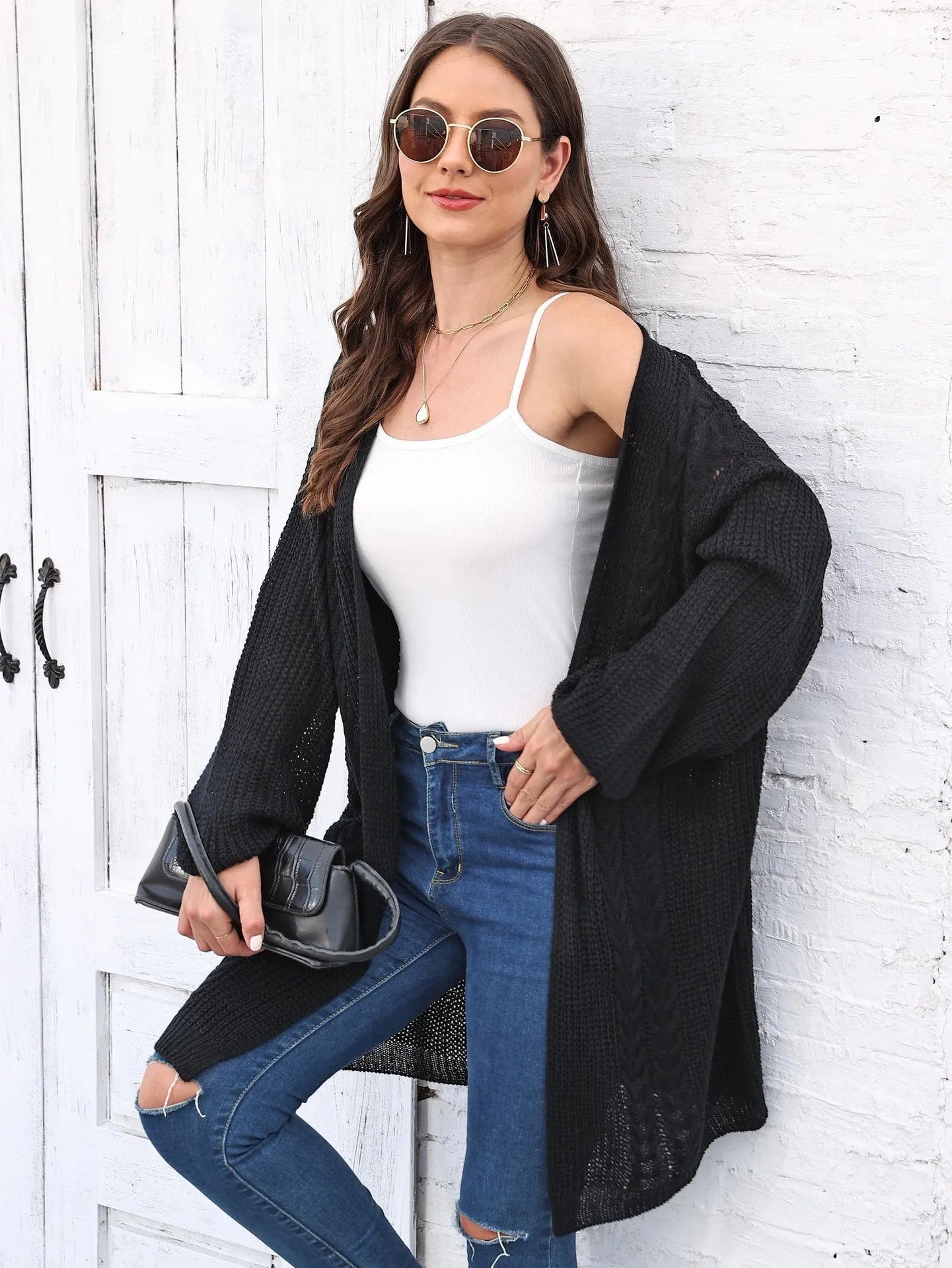 Women's loose brown acrylic sweater coat hanging on a hanger
