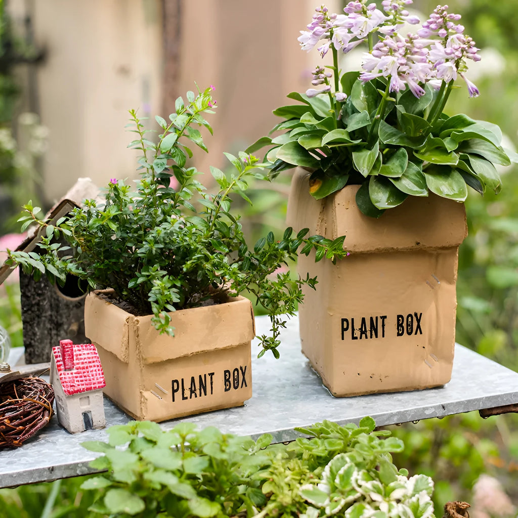 Cement flowerpot styled as a brown paper box with drainage hole for indoor balcony gardening