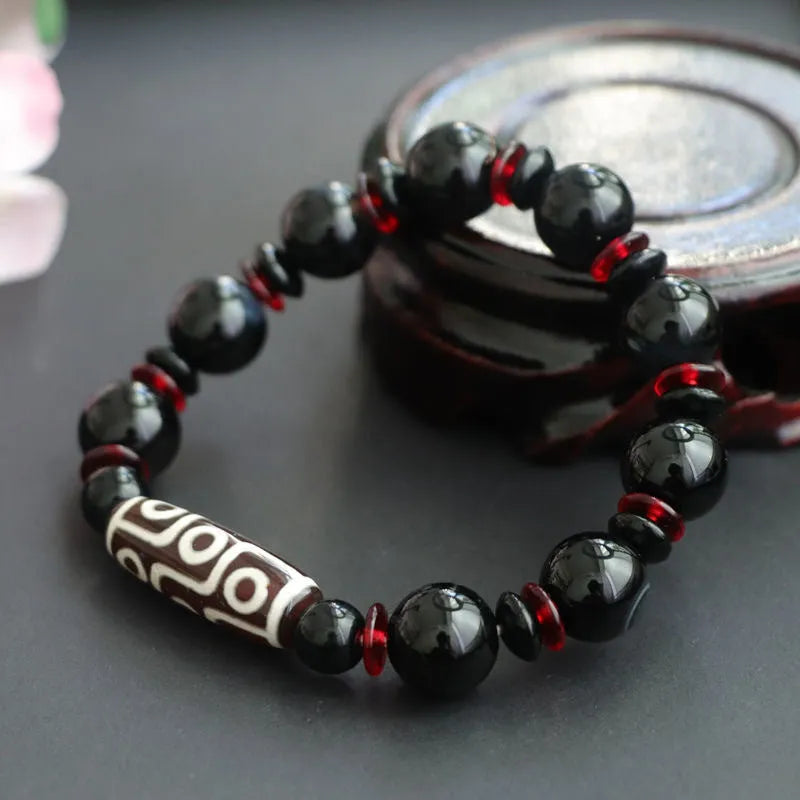 Black agate dzi bead bracelet with geometric pattern and hand-woven construction