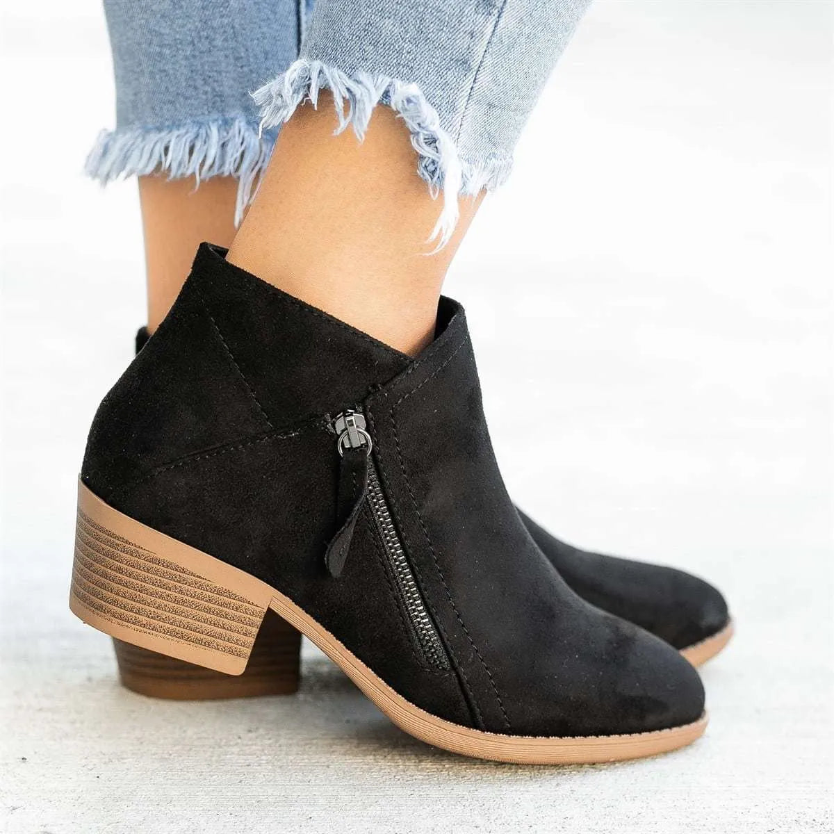 Women's beige suede chunky heel ankle boots with a side zip fastening, shown on a neutral background.