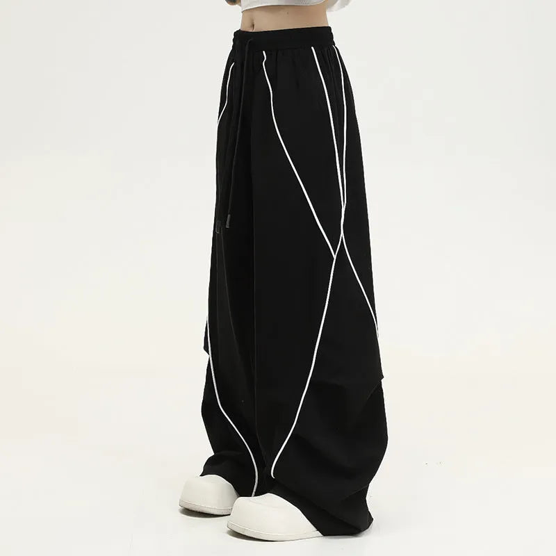 Black wide-leg trousers with vertical stripes and a pleated mid-waistband.