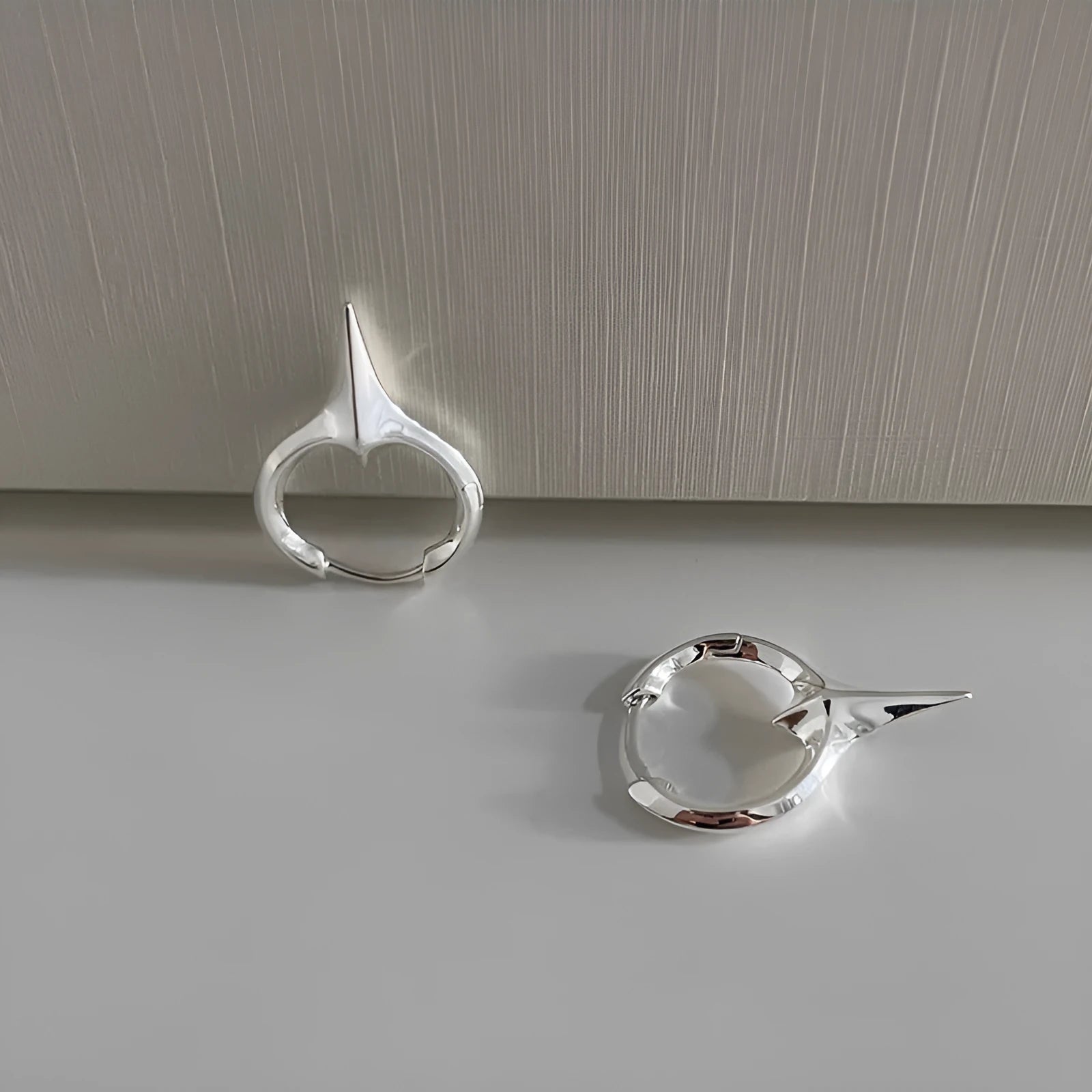 Geometric star shaped ear clips for women with copper construction and platinum electroplated finish