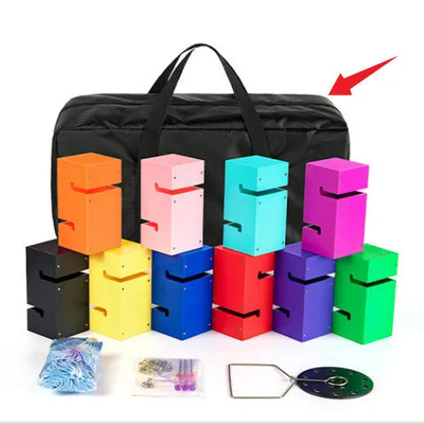 Set of coloured ABS plastic tower blocks with pull ropes and metal hook frame for outdoor team building games.